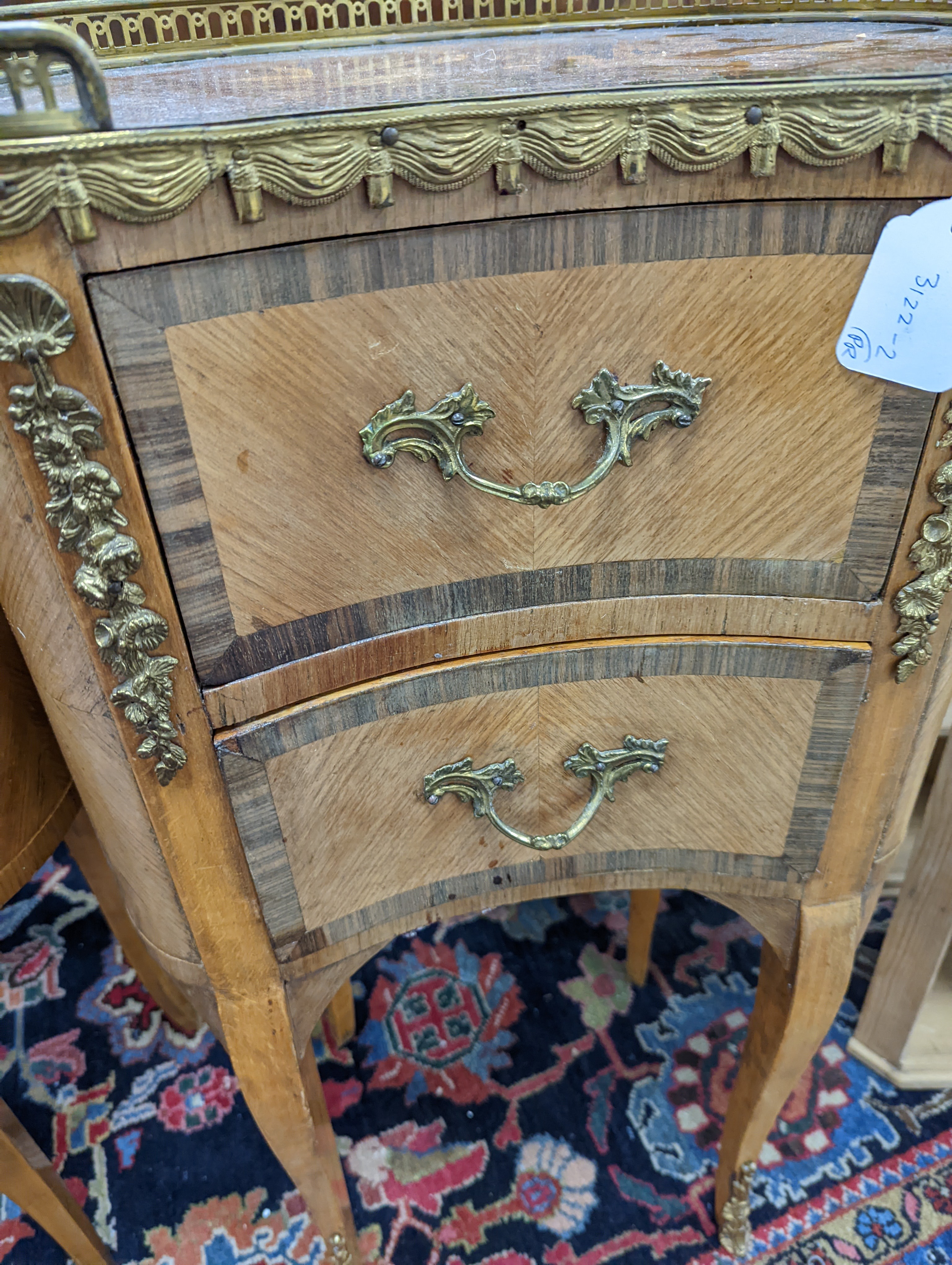 A pair of French marquetry inlaid gilt metal mounted kidney shaped two drawer bedside cabinets, width 42cm, depth 24cm, height 77cm